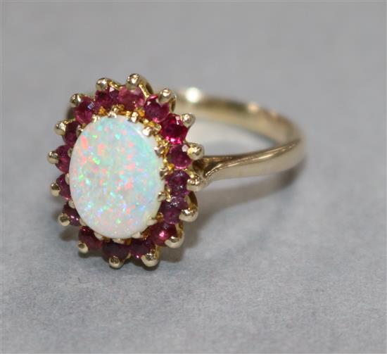 A 9ct gold, white opal and ruby oval cluster ring, size Q.